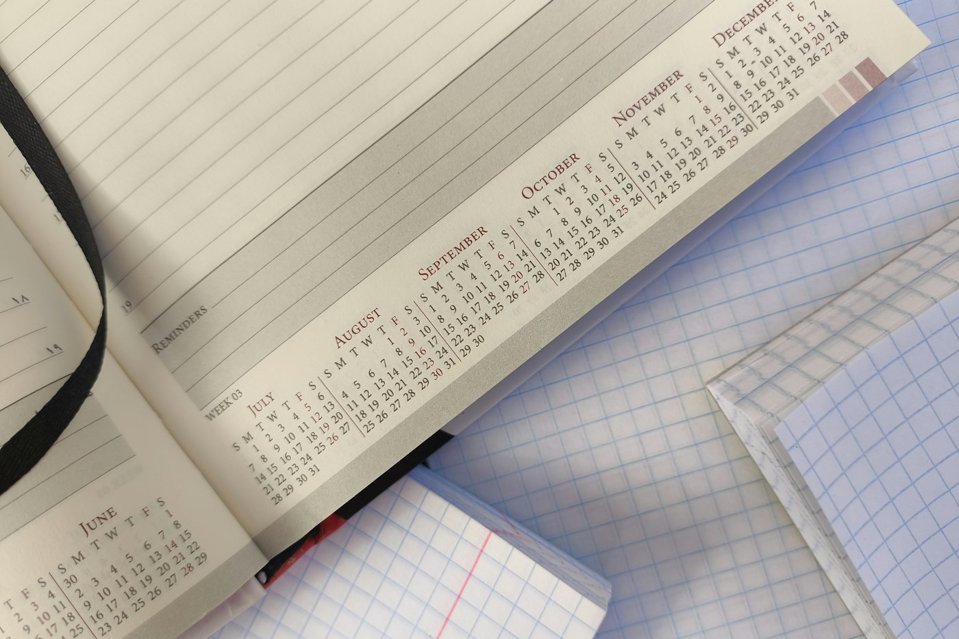 An open diary showing calendar months from June to December