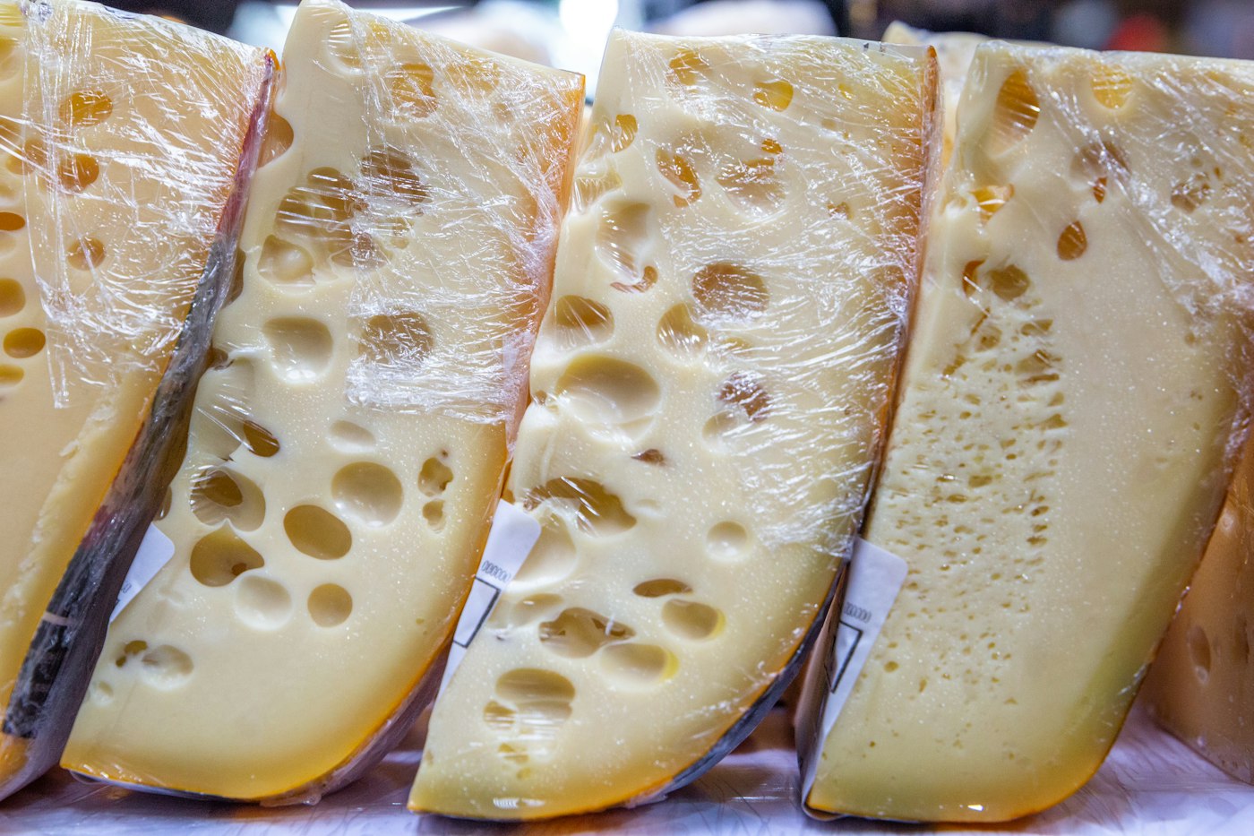 Wedges of Swiss cheese full of holes, lined up side by side
